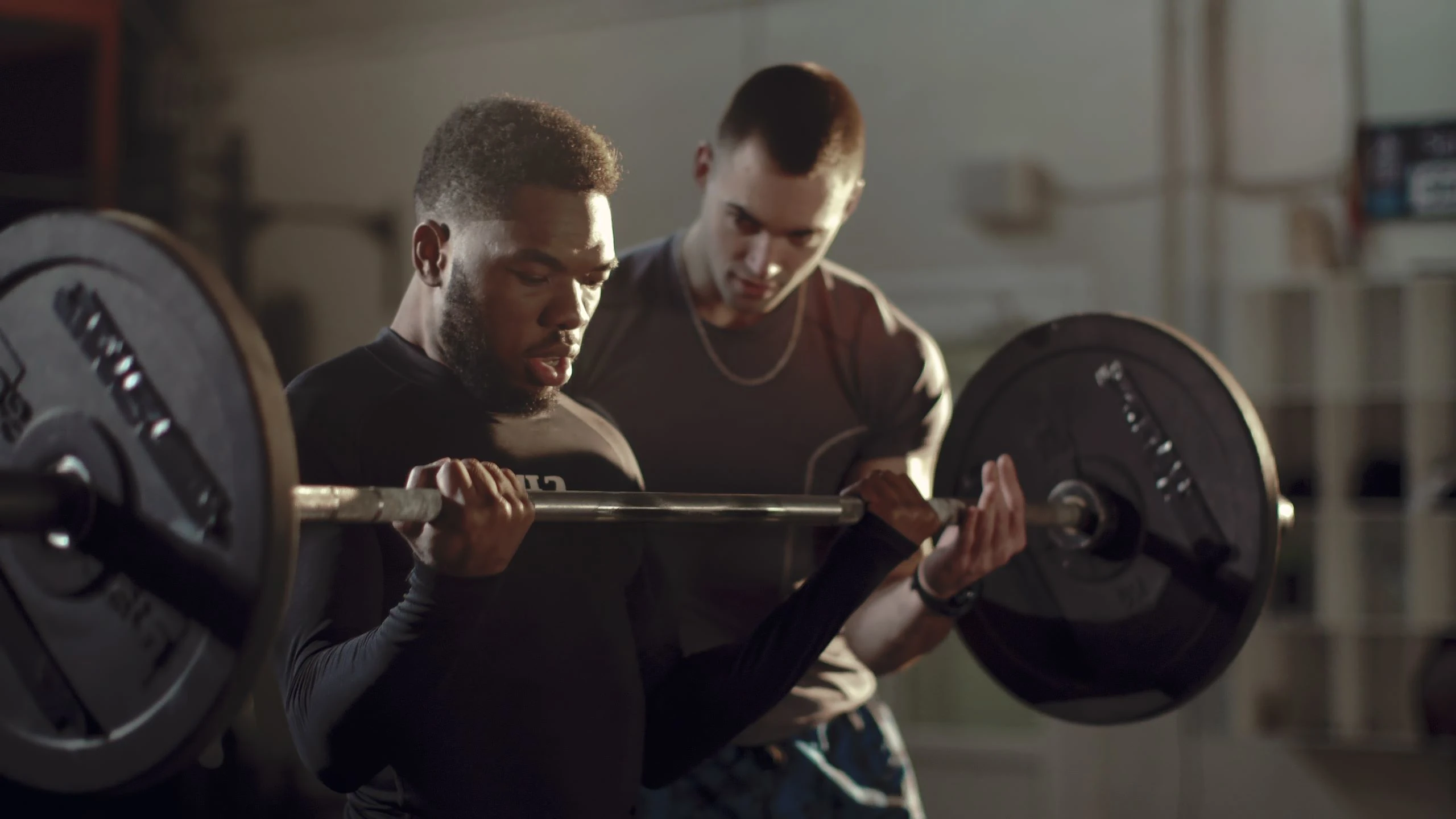 Concentrated African-american Training Bicep With Heavy Barbell Under Control